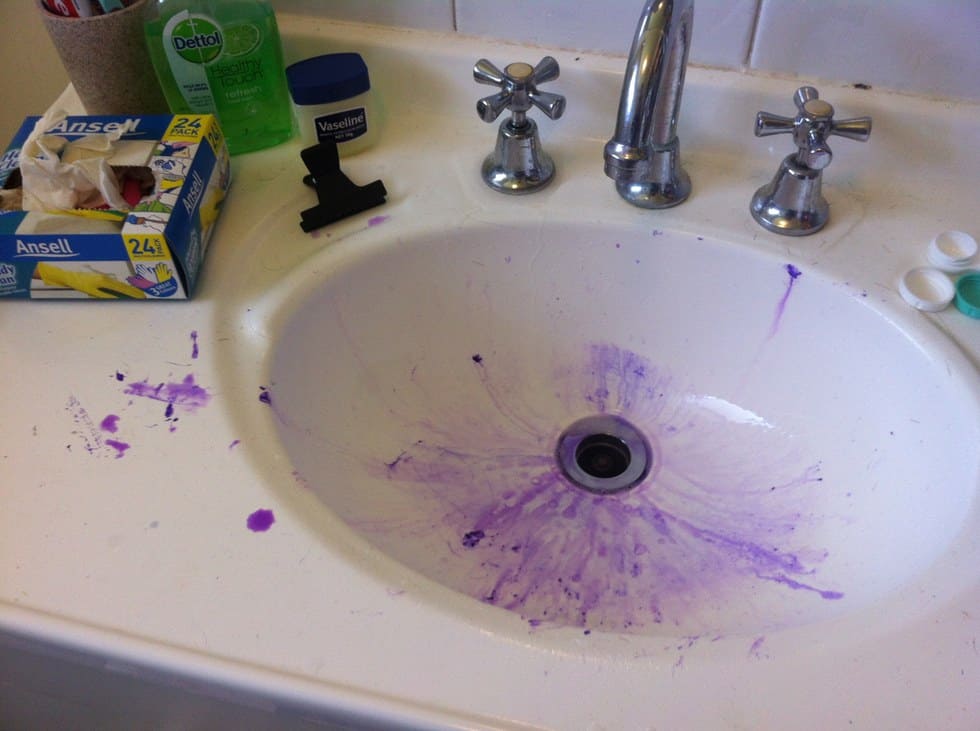 A sink that’s messy with purple hair dye