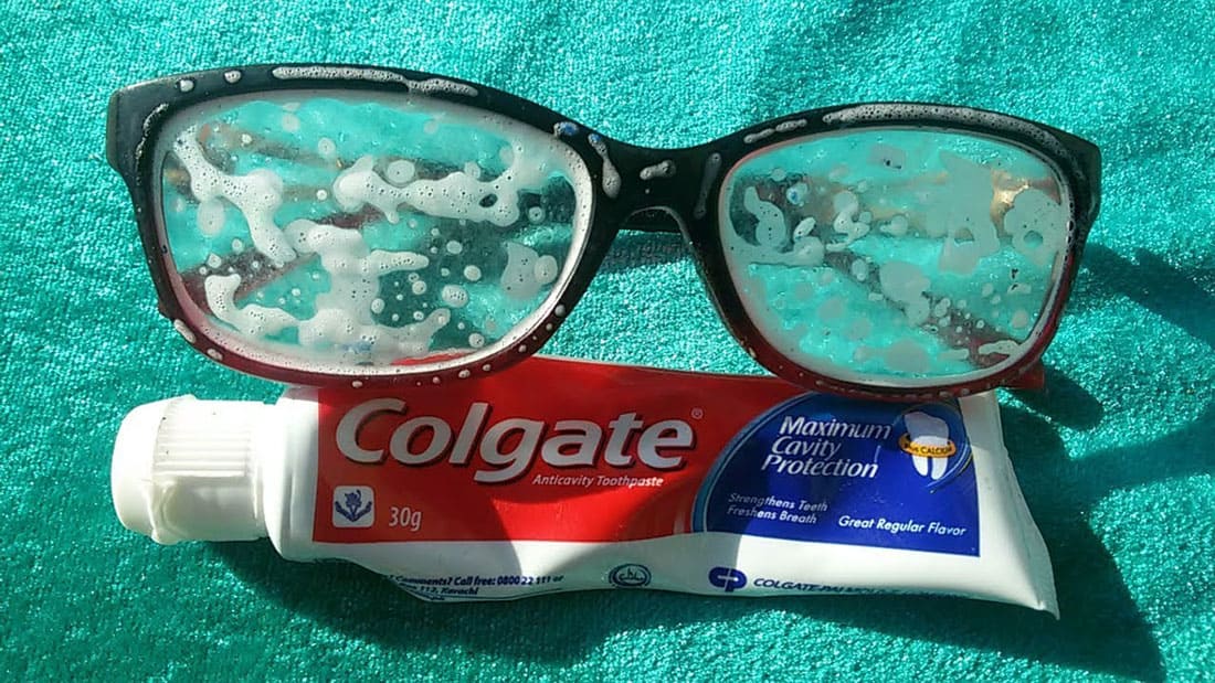 A tube of toothpaste under a pair of glasses