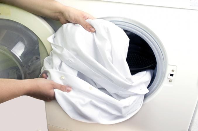 A clean white shirt coming out of the washing machine