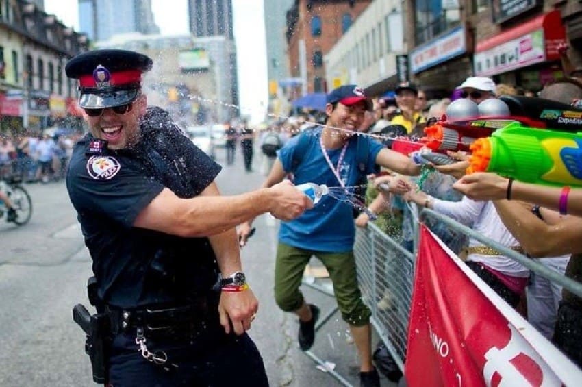 Canadian cop having a water fight with citizens