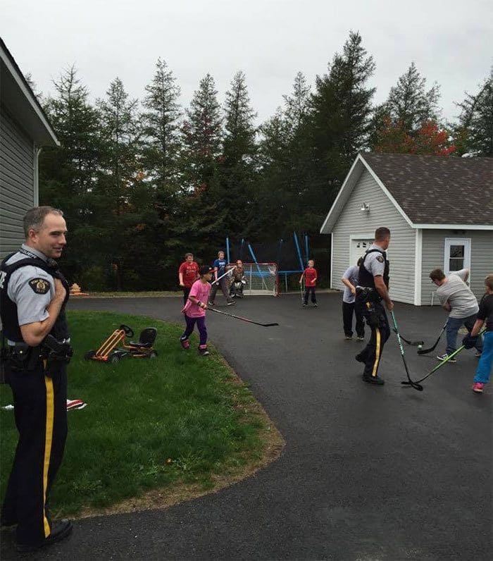 Cops and kids playing street hockey