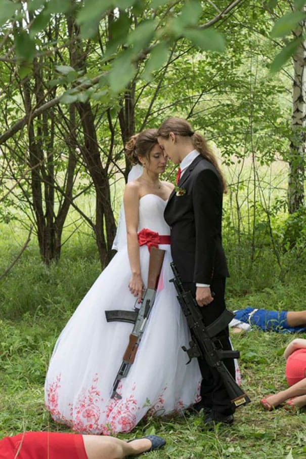 married couple holding rifles 