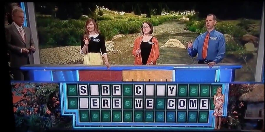 Wheel of Fortune puzzle reading “S_RF C_ _ Y, _ERE WE COME”