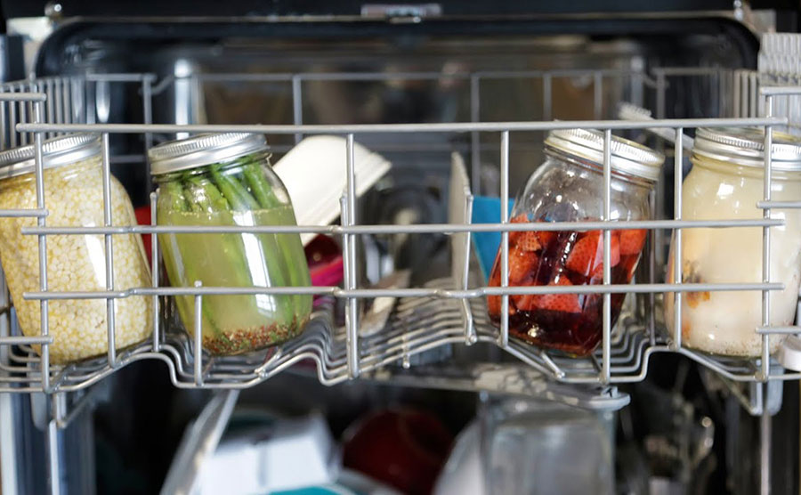 Mason jars with different foods in the dishwasher 