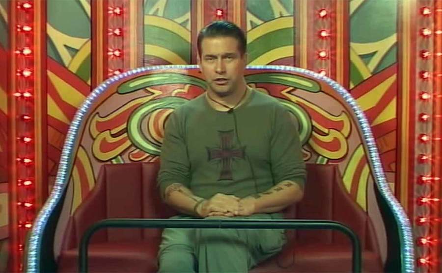 Stephen Baldwin sitting in a carnival ride in the diary room of the show Celebrity Big Brother 