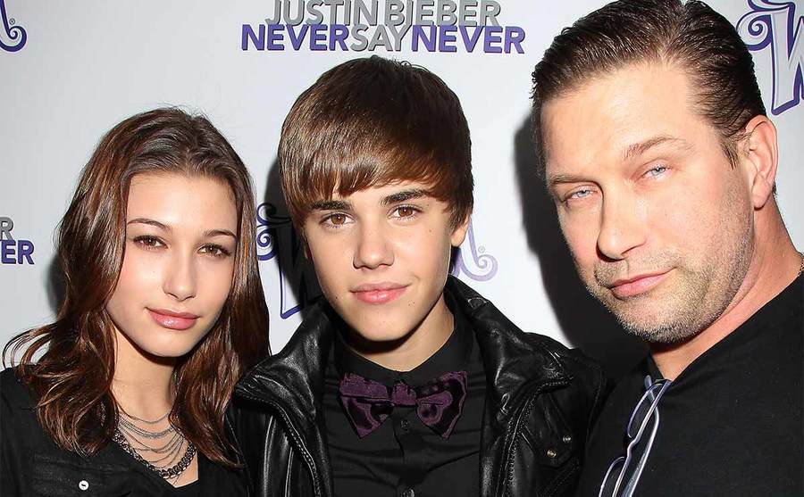 Hailey Bieber, Justin Bieber, and Stephen Baldwin posing together on the red carpet 