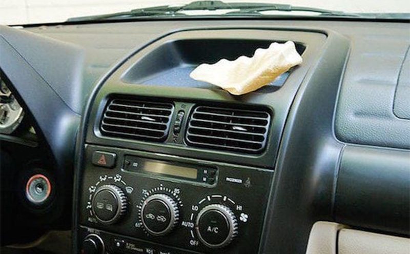 A coffee filter sitting on the top of a car dashboard 