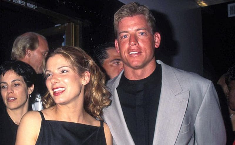 Sandra Bullock and Troy Aikman posing together at an event 