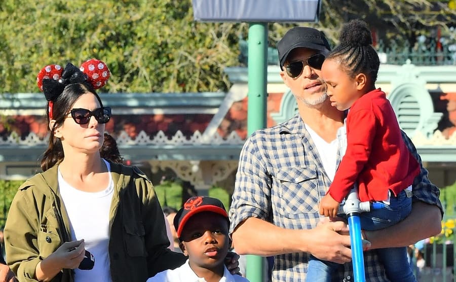 Sandra Bullock, Bryan Randall, and their two children at Disney World