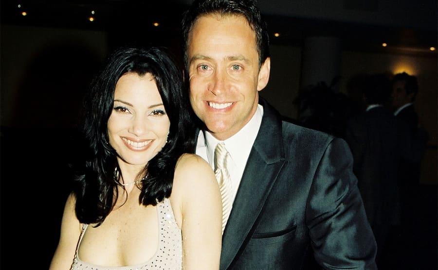 Fran Drescher and Peter Marc Jacobson posing together at a movie premiere in 1997