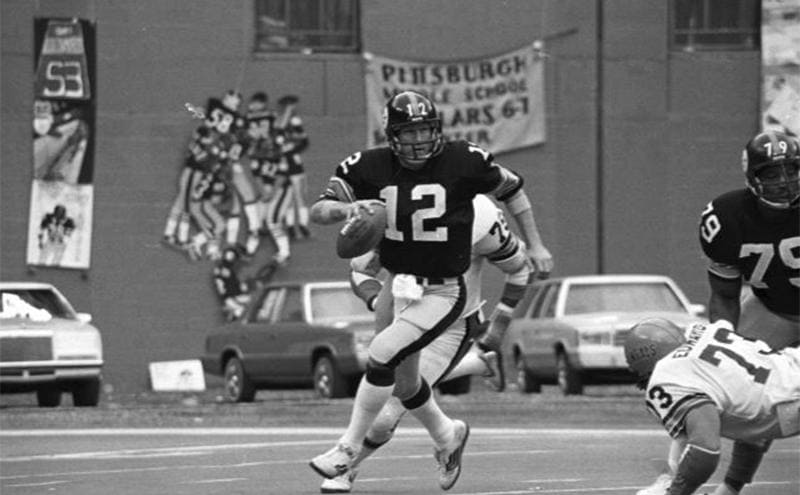 Terry Bradshaw running with the ball during a 1970s Steelers game