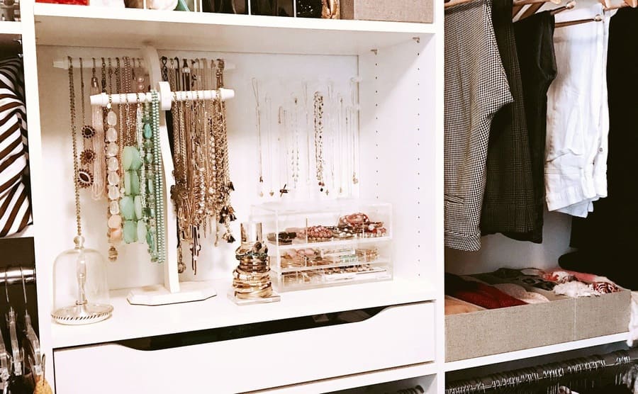 A walk-in closet with jewelry shelves 