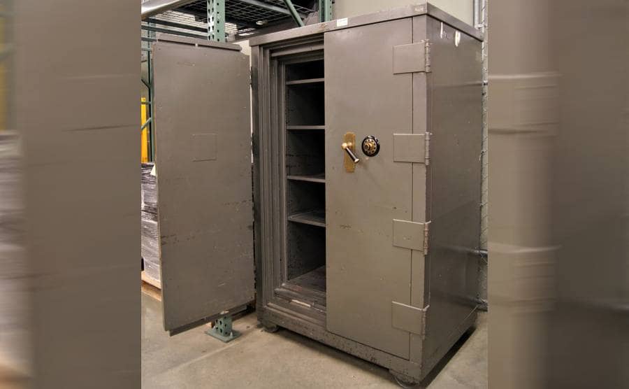 A large metal safe with shelves inside 