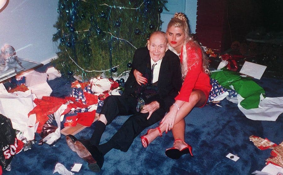 J Howard Marshall and Anna Nicole Smith posing under the Christmas tree 