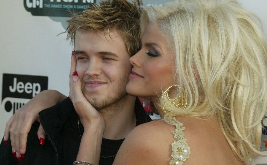 Anna Nicole Smith smiling lovingly while posing with her son Daniel on the red carpet in 2004 