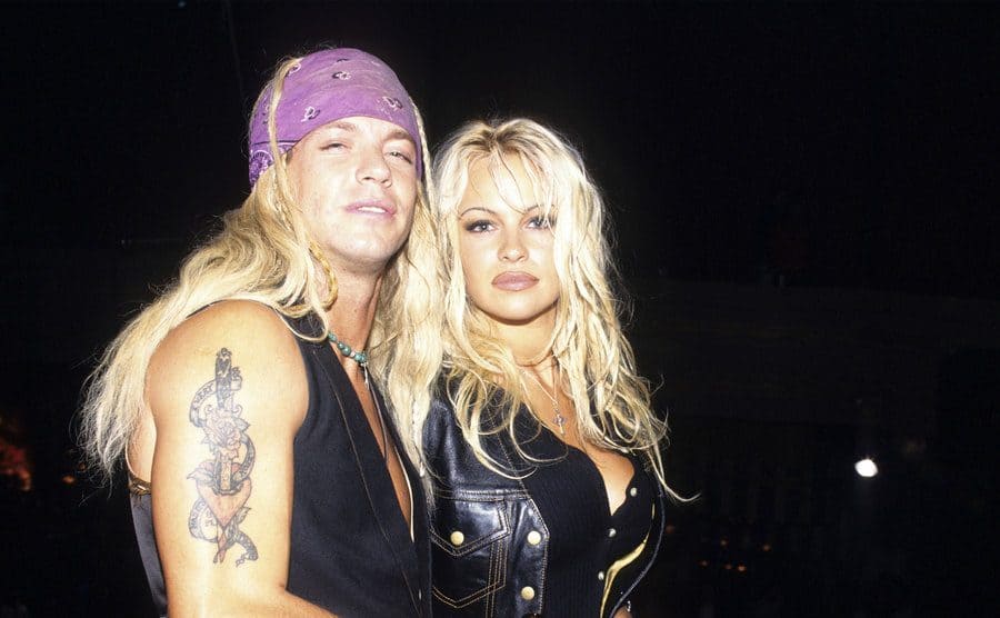 Bret Michaels and Pamela Anderson posing together at an event 