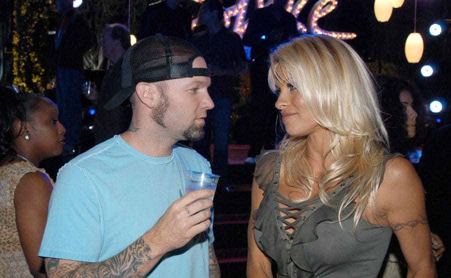 Fred Durst and Pamela Anderson having a conversation at a party 