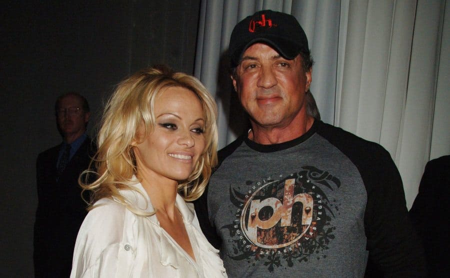 Pamela Anderson and Sylvester Stallone posing at a party together 