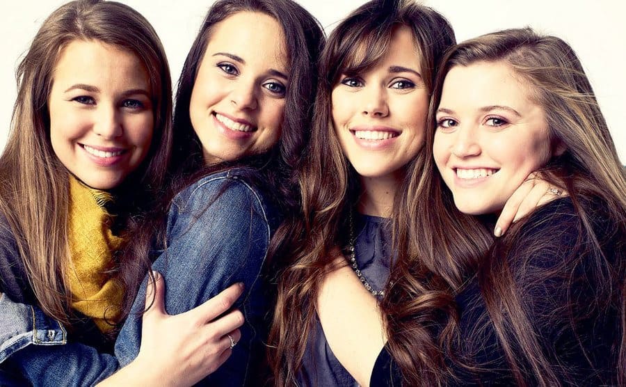 All 4 of the Duggar daughters embracing one and the other for a promotional photo of the show Counting On.