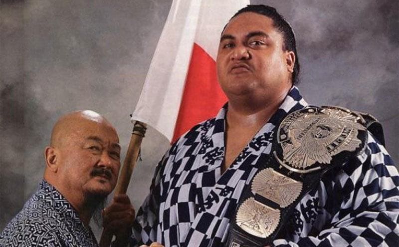 Yokozuna with Mr. Fuji holding a flag and his belt 
