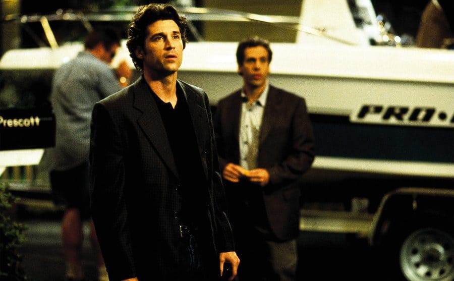 Patrick Dempsey standing in front of a man and a boat in a scene from Scream 3 