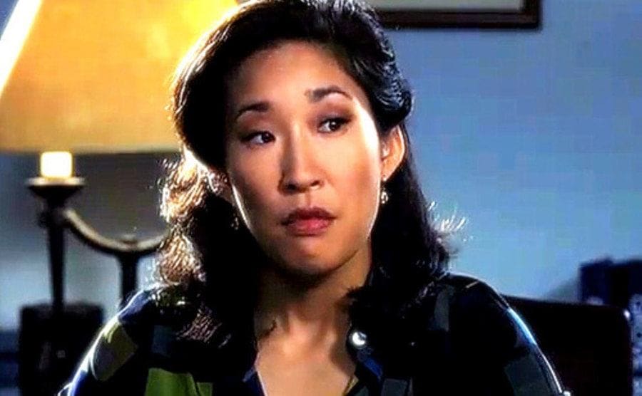 Sandra Oh as the vice principal in The Princess Diaries sititng behind her desk with a stern face 