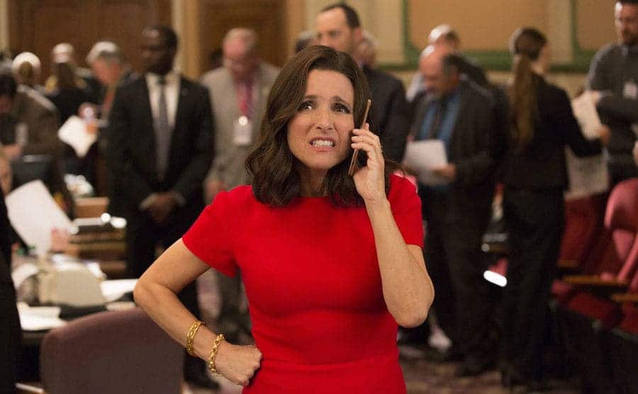 Selina Meyer looking annoyed on the phone in a political setting 