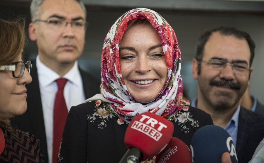Lindsay Lohan wearing a headscarf being interviewed by the press in Turkey 