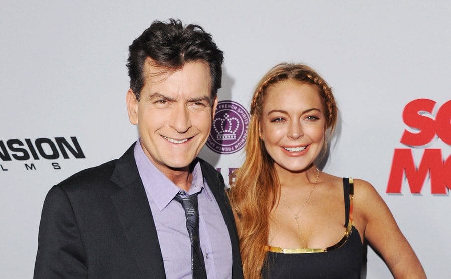 Charlie Sheen and Lindsay Lohan posing on the red carpet together 