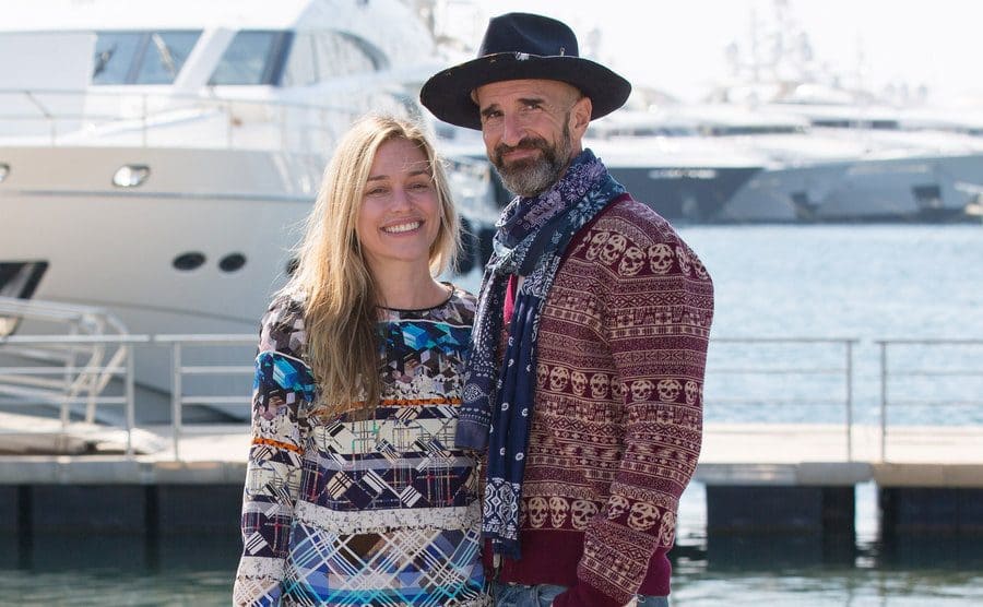 Piper Perabo and Stephan Kay posing together in front of a yacht docked in a port 