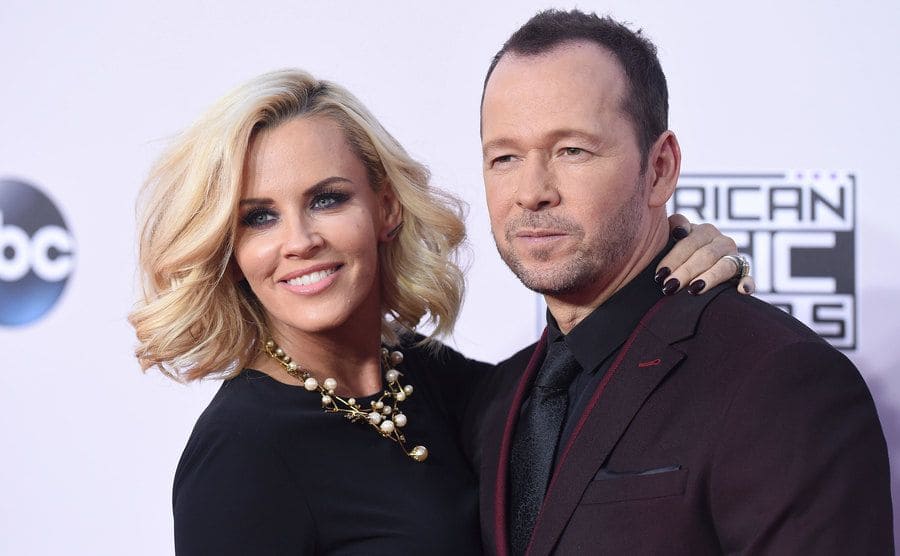 Jennie McCarthy and Donnie Wahlberg arriving at an event 