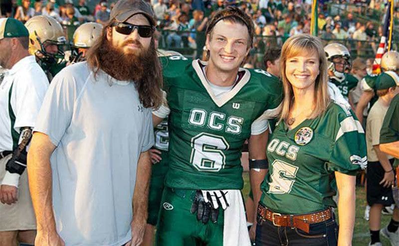Reed and his parents before one of Reed’s football games. 