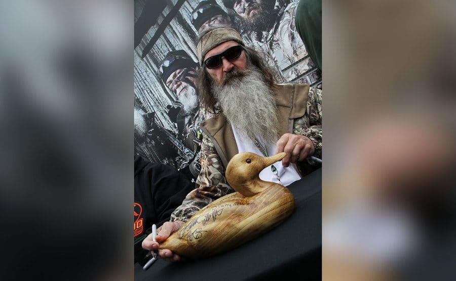 Reality TV personality Phil Robertson greets fans in the Duck Commander Compound.