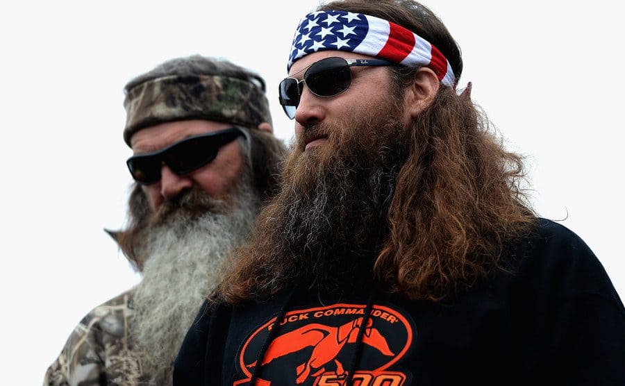 Phil and Willie Robertson take part in pre-race ceremonies for the NASCAR Sprint Cup Series Duck Commander 500