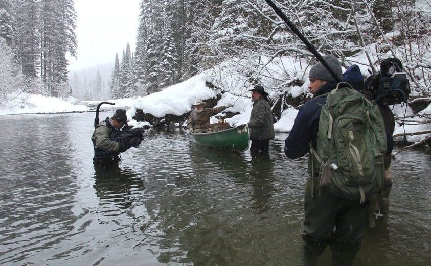 Cameramen filming on location in a freezing cold river for ‘Mountain Men.’