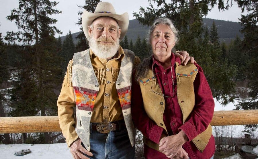 Tom and Nancy of their front porch up in the snowy mountains.