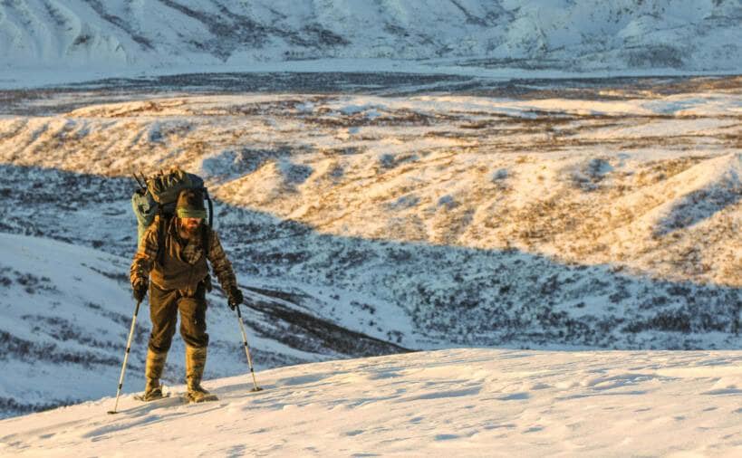 Morgan Beasley walking up a mountain in the snow.