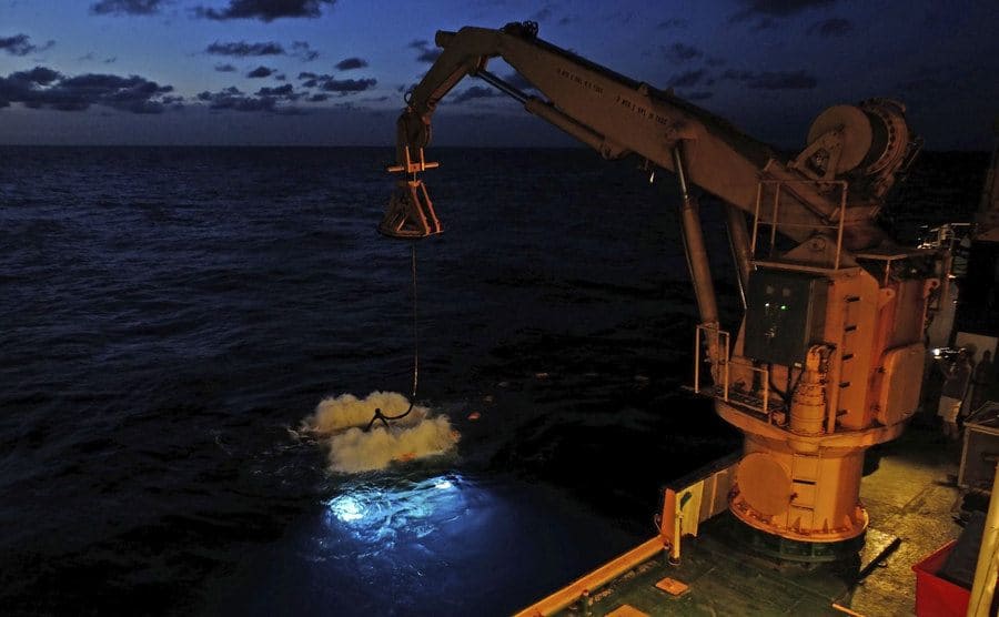 A crane on Thompson’s boat lifting found treasure out of the bottom of the ocean.