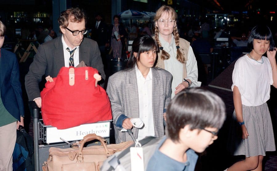 Woody Allen and Mia Farrow at the airport with their children 