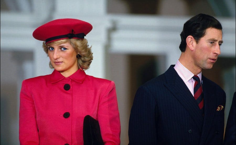 Princess Diana and Prince Charles standing outdoors not looking towards each other 