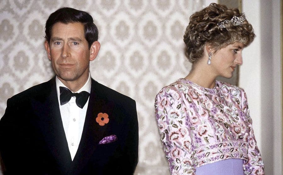 Prince Charles looking at the camera while Princess Diana looks in the other direction