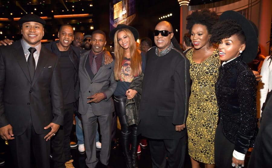 LL Cool J, Jay Z, Jamie Foxx, Beyonce, Stevie Wonder, Aisha Morris, and Janelle Monae posing at an event 
