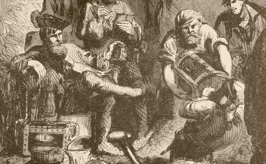 Captain Kidd is seen with his men burying his treasure.