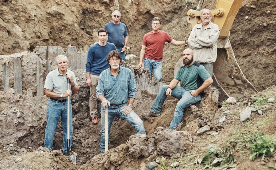 The crew posing for a photo in the money pit during a dig. 