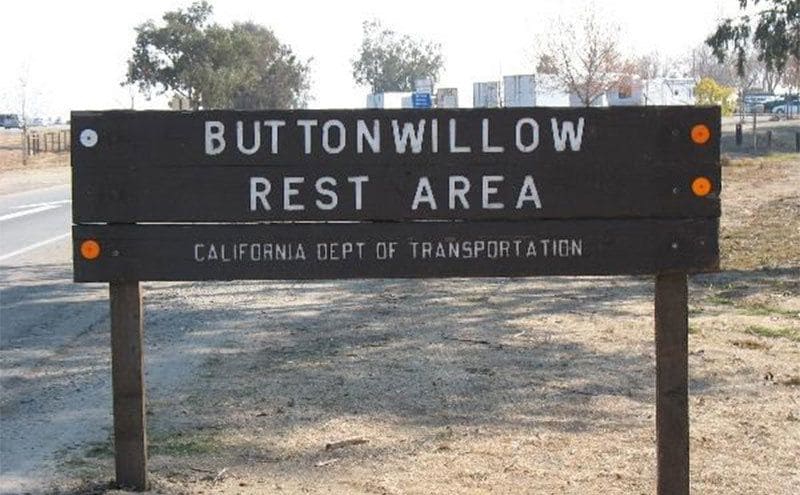 A large wooden sign for the Buttonwillow rest area. 