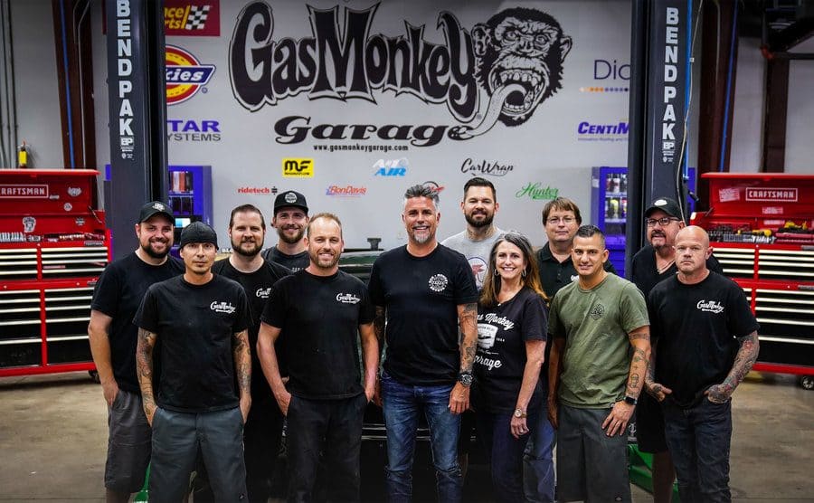 The extended crew of the Gas Monkey Garage posing for a group photo. 