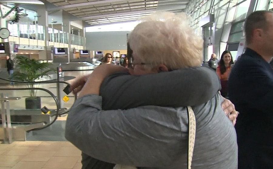 Erin and her mother embrace in an emotional reunion. 