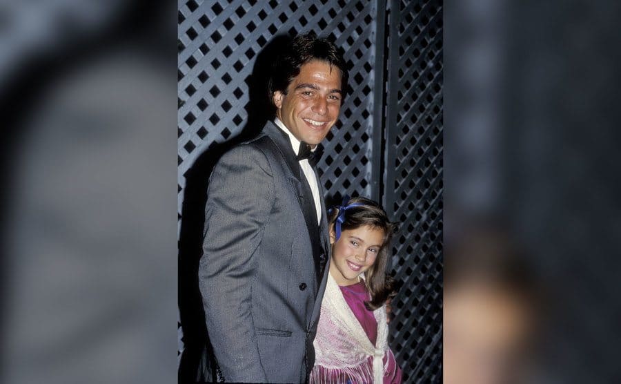 Tony Danza and little Alyssa Milano pose together for a photo. 
