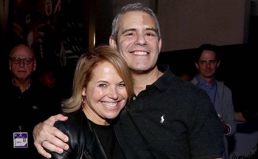 Katie Couric and Andy Cohen are posing together in a shot for the press.