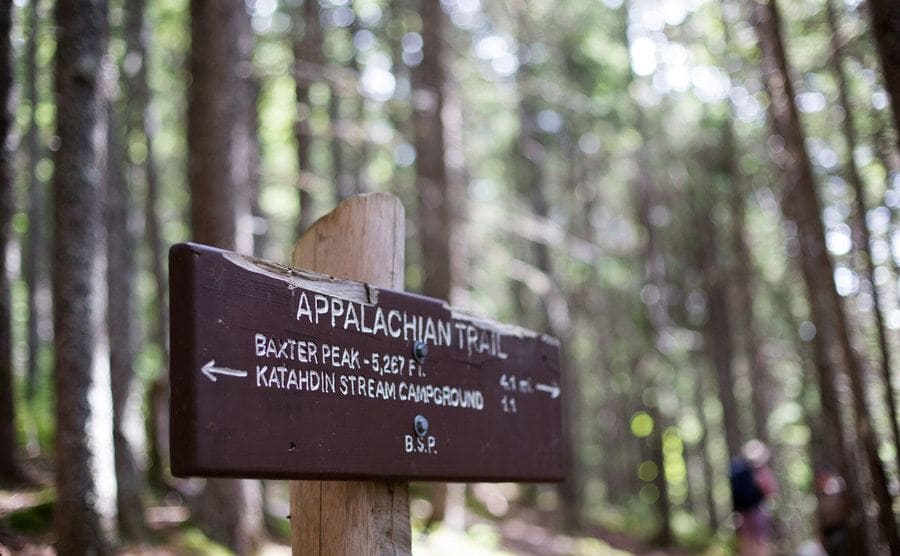 A signpost directs hikers to a section of the Appalachian Trail.
